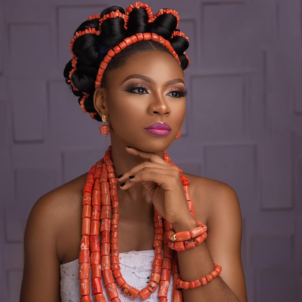 A GIRL DRESSING WITH BEAD